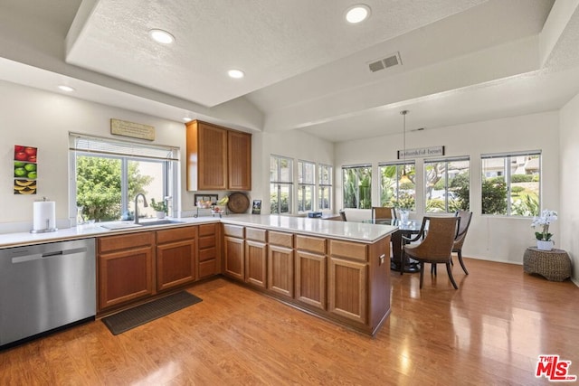 kitchen with kitchen peninsula, sink, stainless steel dishwasher, and plenty of natural light