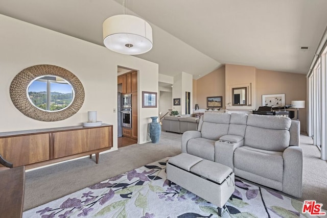 carpeted living room featuring vaulted ceiling