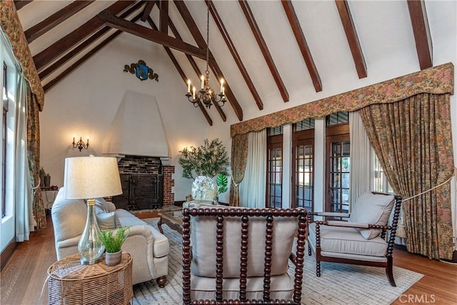 living room with light hardwood / wood-style floors, beam ceiling, high vaulted ceiling, and an inviting chandelier