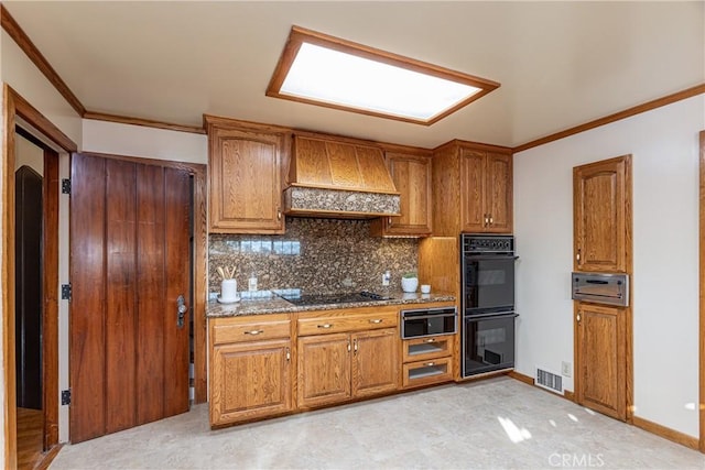 kitchen featuring stone counters, tasteful backsplash, premium range hood, crown molding, and black appliances