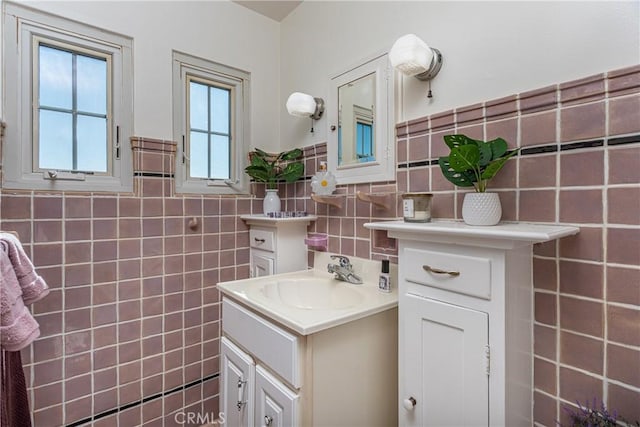 bathroom featuring vanity and tile walls