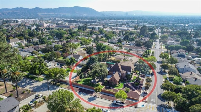 birds eye view of property with a mountain view