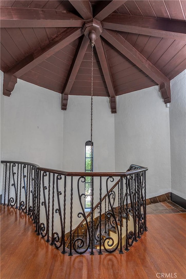 stairs featuring wood ceiling, lofted ceiling with beams, and wood-type flooring