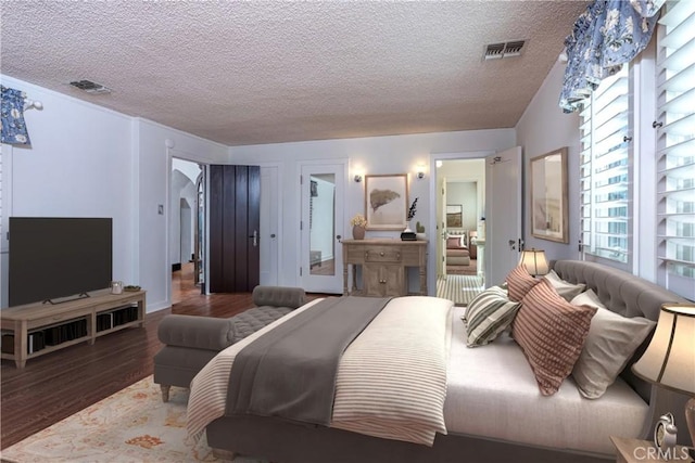 bedroom featuring hardwood / wood-style floors and a textured ceiling