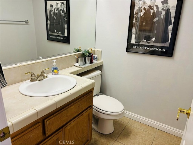 bathroom with tile patterned floors, vanity, toilet, and tasteful backsplash