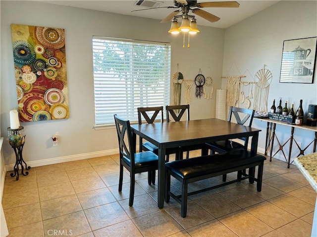 dining area with ceiling fan and light tile patterned flooring