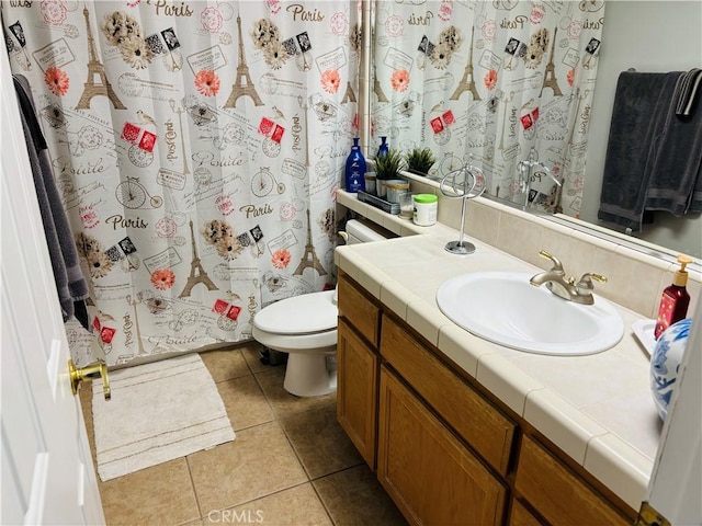 bathroom with tile patterned flooring, vanity, and toilet