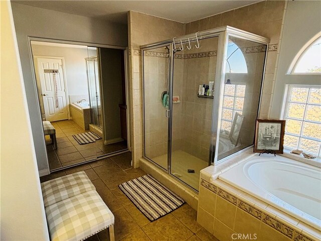 bathroom featuring plus walk in shower and tile patterned floors