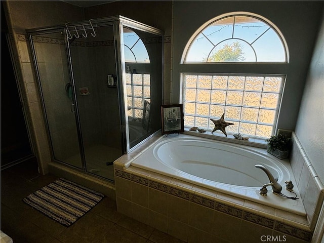 bathroom featuring tile patterned flooring and independent shower and bath