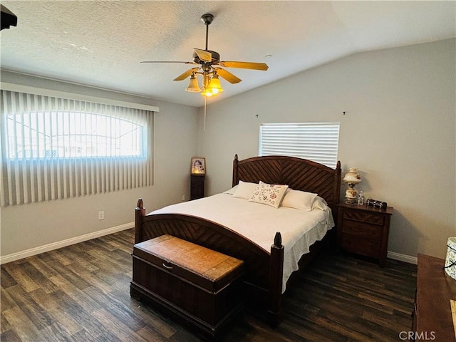 bedroom featuring a textured ceiling, dark hardwood / wood-style flooring, ceiling fan, and lofted ceiling