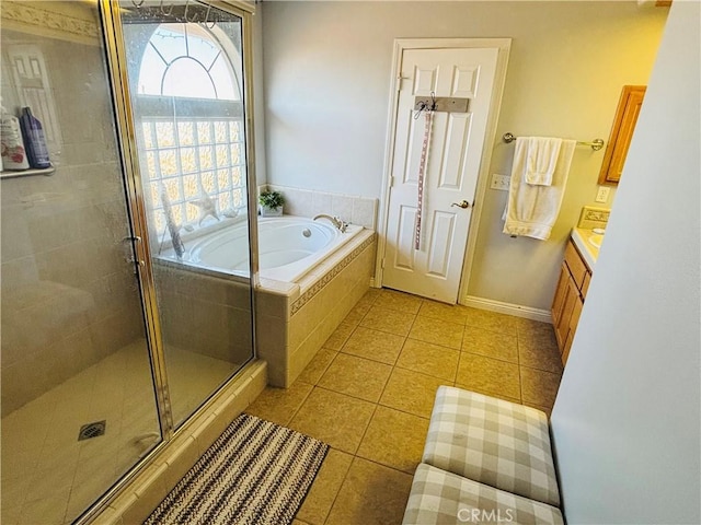 bathroom with plus walk in shower, vanity, and tile patterned floors