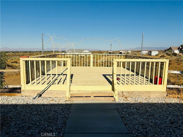 view of yard featuring a deck with mountain view