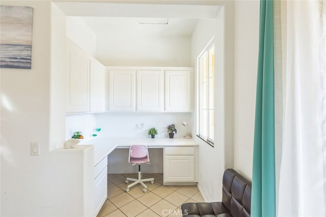 home office featuring built in desk and light tile patterned floors