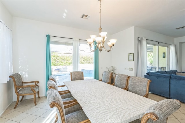 tiled dining area with a notable chandelier