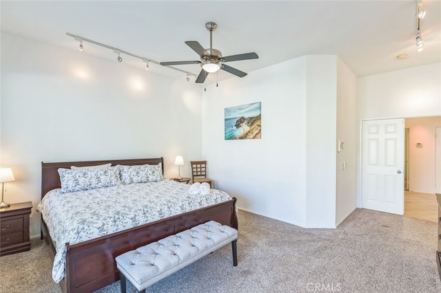 carpeted bedroom featuring ceiling fan and track lighting