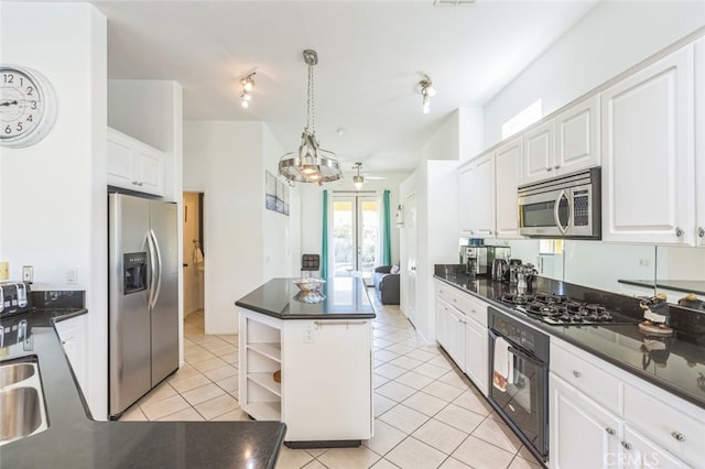 kitchen with pendant lighting, stainless steel appliances, light tile patterned floors, and white cabinetry