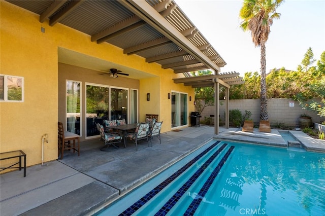 view of swimming pool featuring a patio, a pergola, and ceiling fan