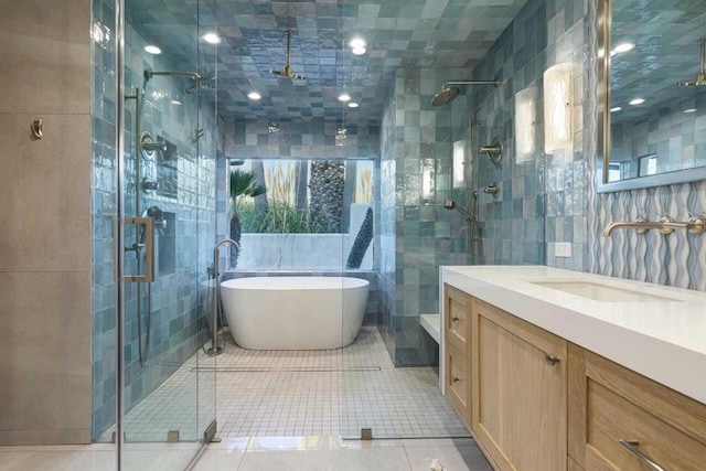 bathroom featuring tile patterned floors, plus walk in shower, and tile walls