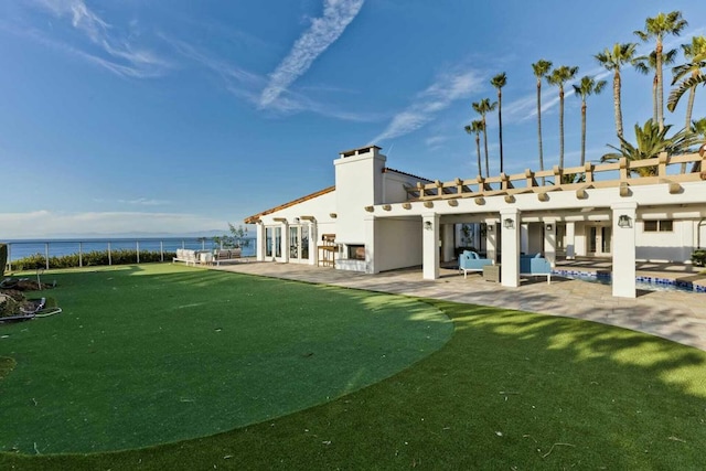 view of yard with a water view and a patio area