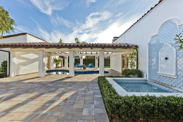 view of swimming pool featuring a patio area and a jacuzzi