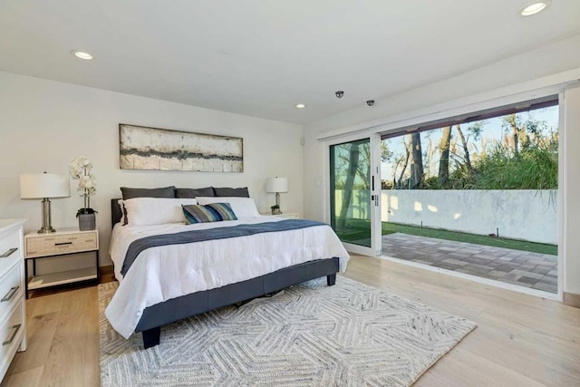 bedroom with access to exterior and light hardwood / wood-style flooring