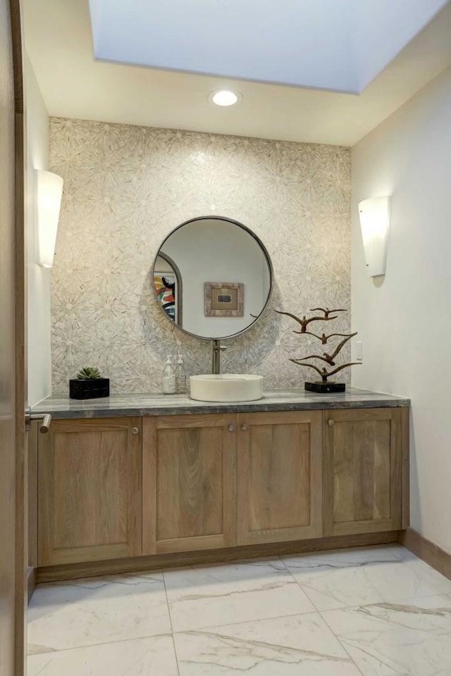 bathroom with a skylight and vanity