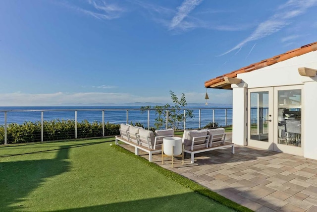 view of patio with outdoor lounge area, a water view, and french doors