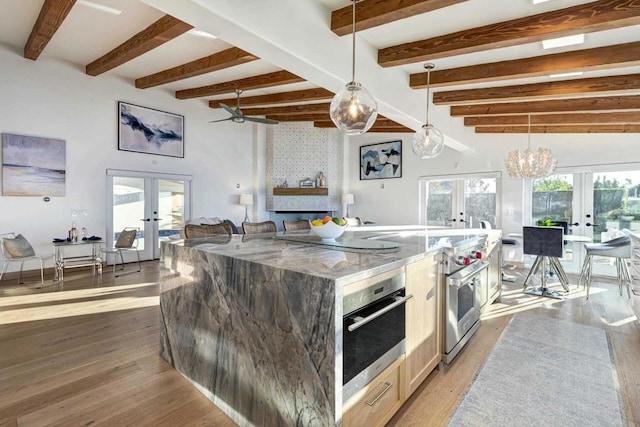 kitchen with a healthy amount of sunlight, hanging light fixtures, and french doors