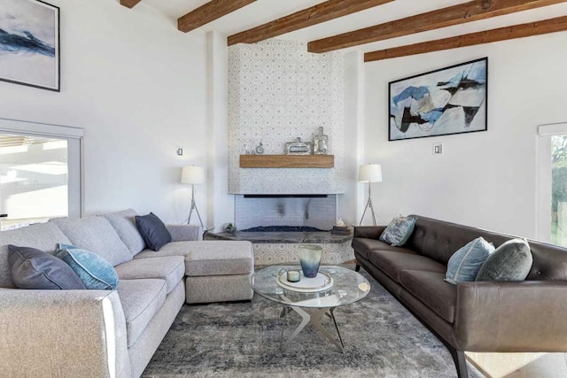 living room with beam ceiling and a fireplace