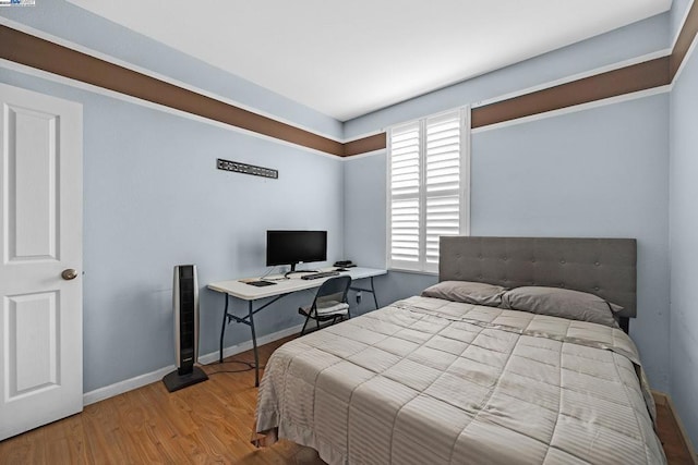 bedroom with hardwood / wood-style flooring