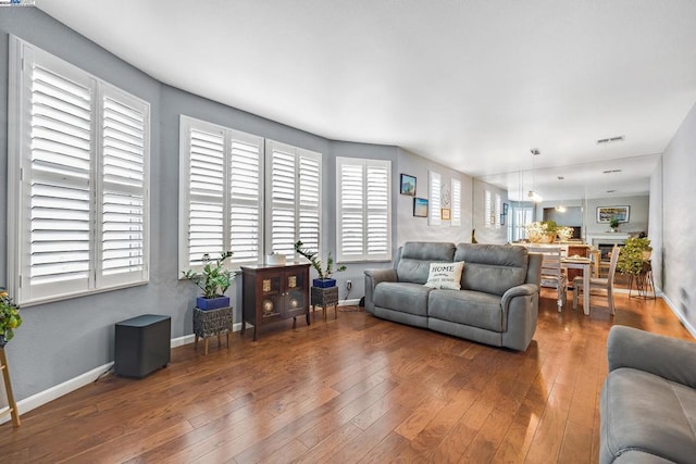 living room with dark hardwood / wood-style flooring