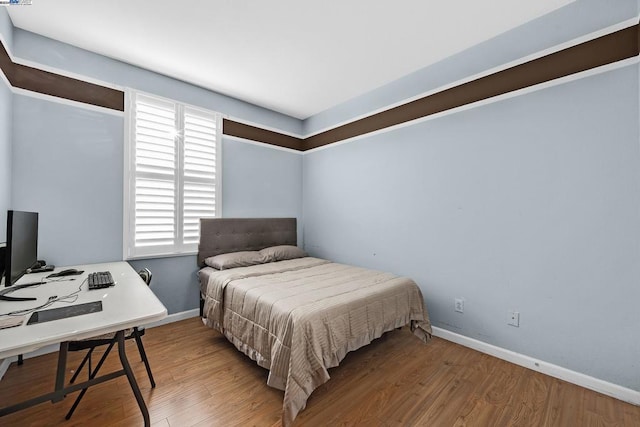 bedroom with hardwood / wood-style flooring