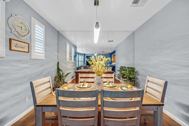 dining space with dark hardwood / wood-style floors