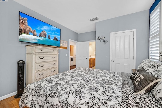 bedroom with light hardwood / wood-style floors and a closet