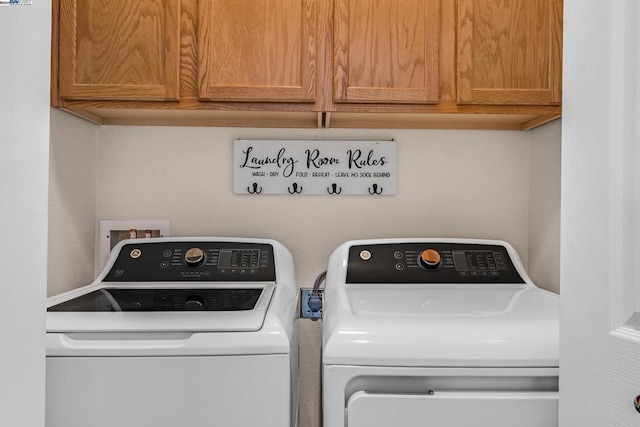 washroom featuring cabinets and independent washer and dryer