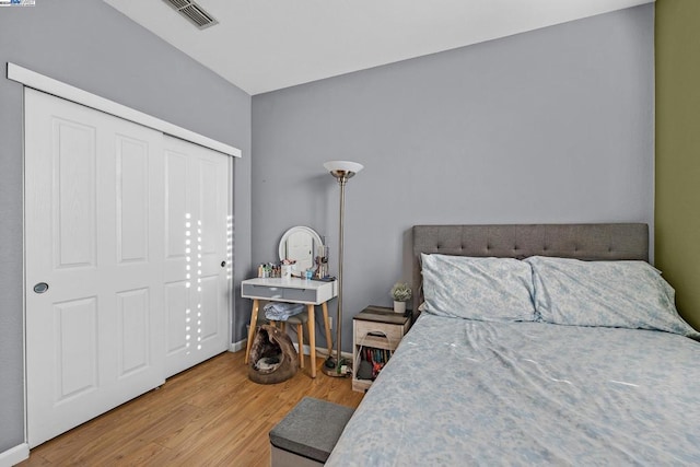 bedroom featuring wood-type flooring and a closet