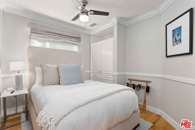 bedroom featuring ornamental molding, light hardwood / wood-style floors, and ceiling fan