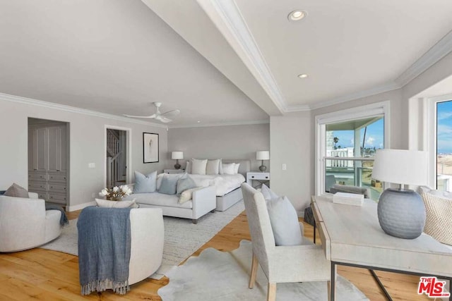 living room with ornamental molding, light hardwood / wood-style floors, and ceiling fan