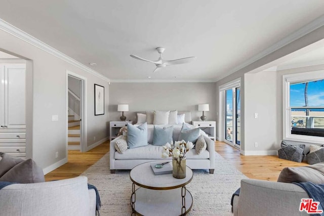 living room with ornamental molding, light wood-type flooring, and ceiling fan