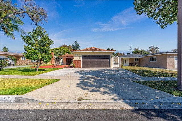 ranch-style house with a garage and a front lawn