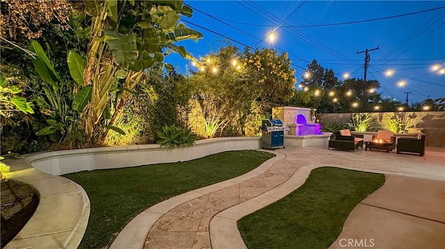 view of yard featuring a fire pit and a patio