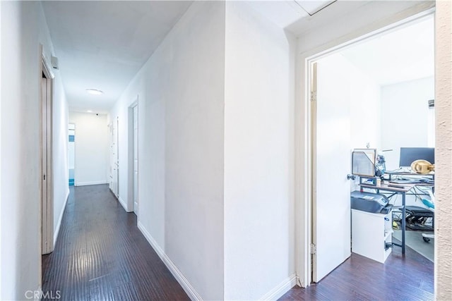 hallway with dark hardwood / wood-style floors