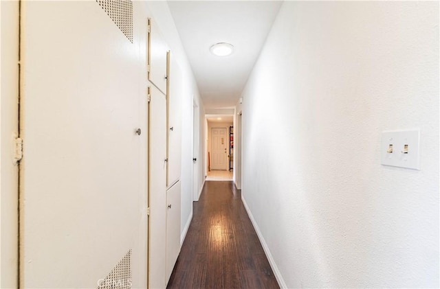 hall with dark hardwood / wood-style flooring