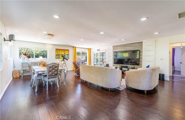 living room featuring dark hardwood / wood-style floors and plenty of natural light