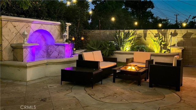 view of patio / terrace with an outdoor living space with a fire pit