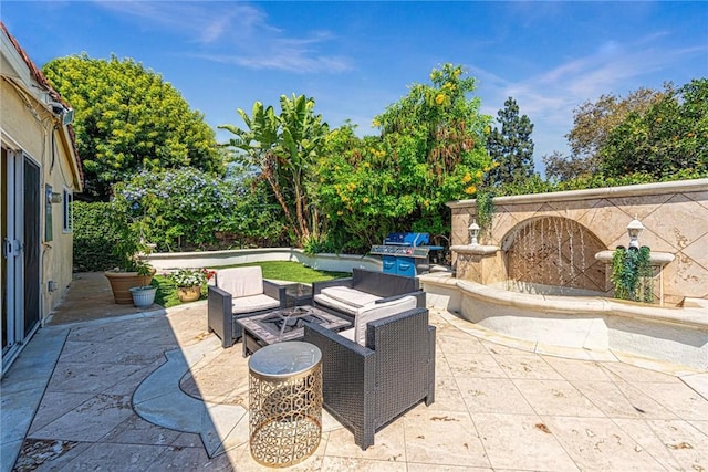 view of patio / terrace with area for grilling and an outdoor fire pit