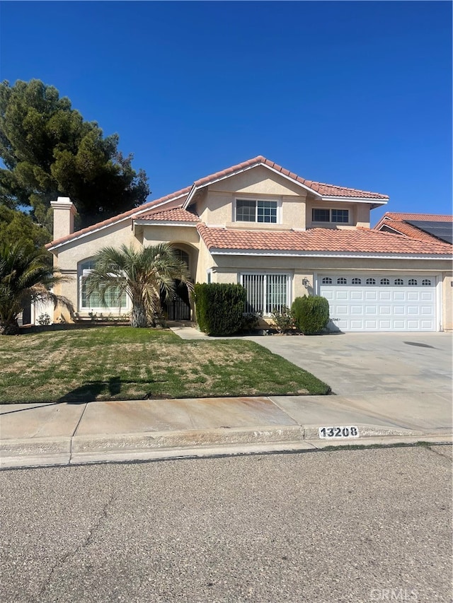 mediterranean / spanish home featuring a front yard