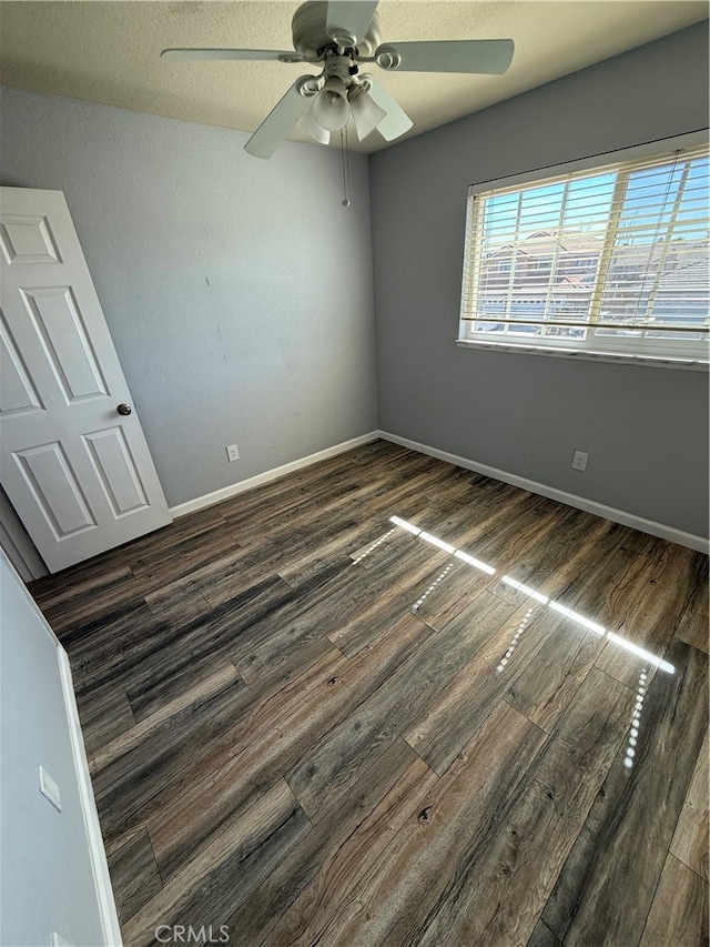 unfurnished bedroom featuring ceiling fan, a textured ceiling, and dark hardwood / wood-style flooring