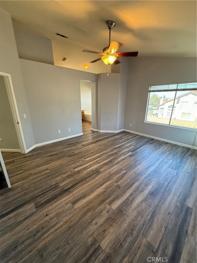 empty room featuring ceiling fan, a textured ceiling, and dark hardwood / wood-style flooring