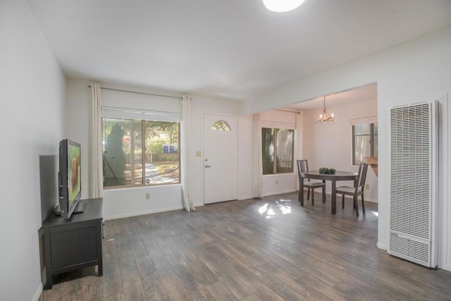 foyer entrance featuring a chandelier and dark hardwood / wood-style flooring